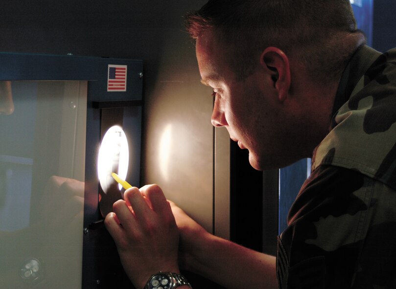Staff Sgt. Jon Shortsleeve, 388th EMS, nondestructive inspection craftsman, evaluates a radiograph of a main engine control for the position of the filter tube. (U.S. Air Force photo by Airman 1st Class Stefanie Torres)