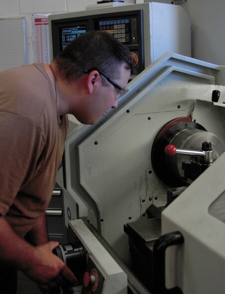 Staff Sgt. William White, 388th EMS aircraft metals technician, turns a piece of metal to take the outer coating off to clean it for weld certification. (U.S. Air Force photo by Airman 1st Class Stefanie Torres)