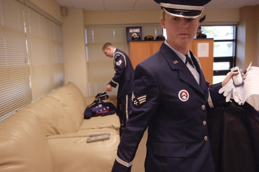 Senior Airman Rebecca Carey, 437th Medical Group, and Staff Sgt. Michael Fronk, 437th Communications Squadron, gather their gear prior to a ceremony. (U.S. Air Force photo/Senior Airman Desiree N. Palacios)