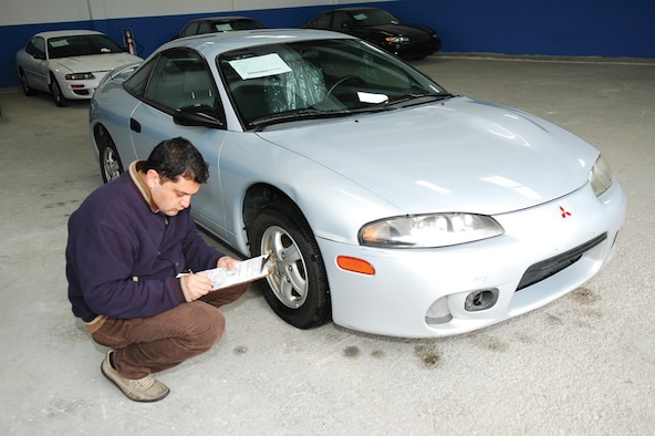 An Incirlik Delta Shipping vehicle inspector inspects a car prior to shipment.  (U.S. Air Force photo by Master Sgt. Bill Gomez)