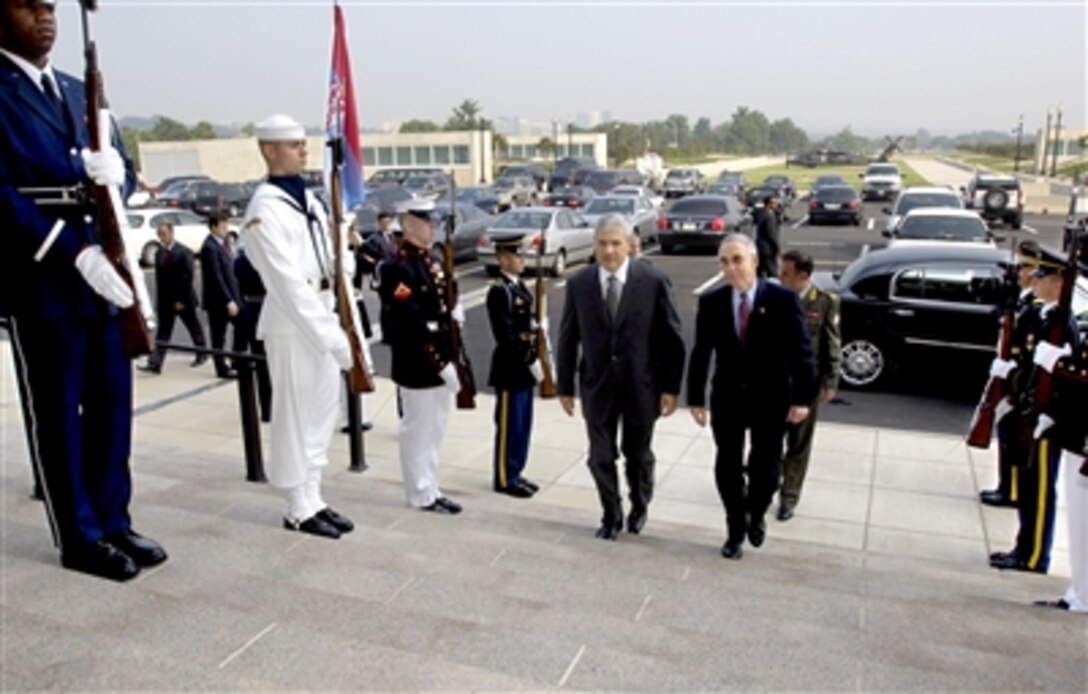 Serbian President Boris Tadic (left) arrives at the Pentagon and is escorted through an honor cordon and into the building by Deputy Secretary of Defense Gordon England on Sept. 8, 2006.  England will host security talks with Tadic and his delegation.  
