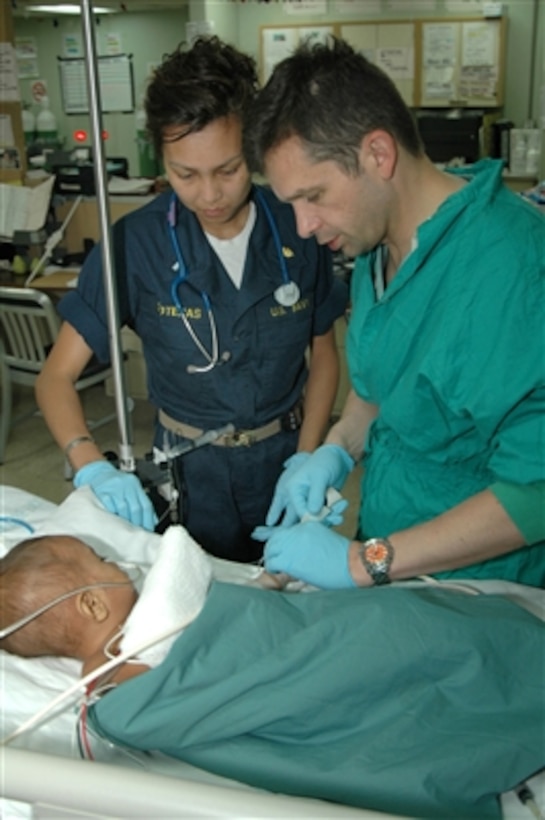U.S. Navy Lt. j.g. Catherine Soteras observes as Cmdr. Dale Szpisjak administers anesthetic to a patient aboard the hospital ship USNS Mercy (T AH 19) on Aug. 31, 2006, off the coast of Dili, East Timor.  The Mercy is in the area providing medical care and humanitarian and civic assistance during its five-month deployment to South Asia, Southeast Asia and the Pacific Islands.  