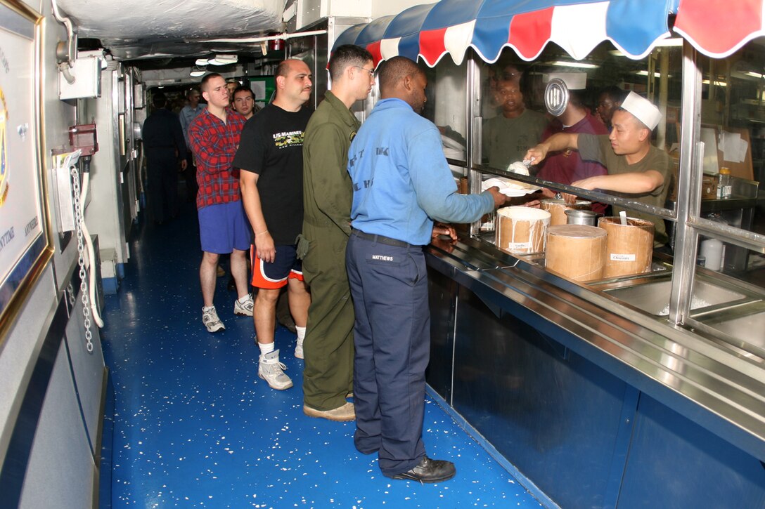 ABOARD USS PELELIU (LHA 5) (Oct. 29, 2008) -- Sailors with the USS Peleliu (LHA 5), Marines with the 15th Marine Expeditionary Unit and "Tigers" line up for an ice cream social as part of "Operation Tiger Cruise". ::r::::n::   Operation Tiger Cruise is a program which brings civilian friends and family of deployed Marines and Sailors for the final leg of a deployment from Pearl Harbor, Hawaii to San Diego, Calif. aboard U.S. Navy vessels.::r::::n::   During Tiger Cruise, Tigers see the day-to-day operations their service members experience during deployment, including eating in the mess decks and sleeping in troop berthing. ::r::::n::    The Camp Pendleton, Calif. based 15th MEU is comprised of approximately 2,200 Marines and Sailors and is a forward deployed force of readiness capable of conducting numerous operations, such as Non-Combatant Evacuation Operations, Humanitarian Assistance Operations and a wide range of amphibious missions. ::r::::n::   The 15th MEU is currently on the final leg of deployment. (Official USMC photo by Cpl. Timothy T. Parish) (Released)::r::::n::