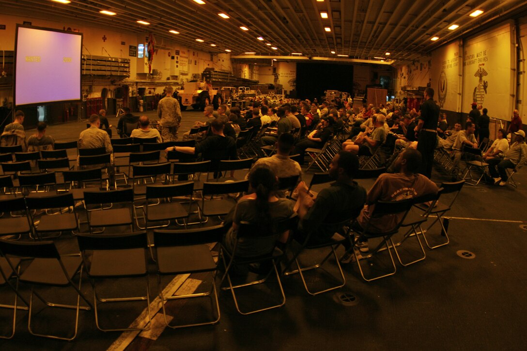 ABOARD USS PELELIU (LHA 5) (Oct. 29, 2008) -- Sailors with the USS Peleliu (LHA 5), Marines with the 15th Marine Expeditionary Unit and "Tigers" grab a seat during a Cinema at Sea in the hangar bay aboard USS Peleliu (LHA 5).::r::::n::   Operation Tiger Cruise is a program which brings civilian friends and family of deployed Marines and Sailors for the final leg of a deployment from Pearl Harbor, Hawaii to San Diego, Calif. aboard U.S. Navy vessels.::r::::n::   During Tiger Cruise, Tigers see the day-to-day operations their service members experience during deployment, including eating in the mess decks and sleeping in troop berthing. ::r::::n::    The Camp Pendleton, Calif. based 15th MEU is comprised of approximately 2,200 Marines and Sailors and is a forward deployed force of readiness capable of conducting numerous operations, such as Non-Combatant Evacuation Operations, Humanitarian Assistance Operations and a wide range of amphibious missions. ::r::::n::   The 15th MEU is currently on the final leg of deployment. (Official USMC photo by Cpl. Timothy T. Parish) (Released)::r::::n::