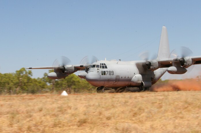 In the wide open spaces of Australia's Northern Territory lies a small 3,500 foot dirt runway where KC-130 Hercules pilots, from Marine Aerial Refueler Transport Squadron 152, 1st Marine Aircraft Wing, conduct Assault Landing Zone training for Exercise Southern Frontier, Sept. 8. In addition to providing refueling assistance to fixed-wing aircraft, the Sumos' pilots use these fly-bys to hone their skills while Marines from Marine Wing Support Squadron 172 visually spot the landings on the ground and radio the results back to the pilot so adjustments can be made. "This training is valuable because you're not always going to have a perfectly paved road to land on," said Sgt. Julien L. Russell, MWSS-172 expeditionary airfield systems technician. "This is what they use in Iraq every day. "When you're in combat you don't have time to mess up."