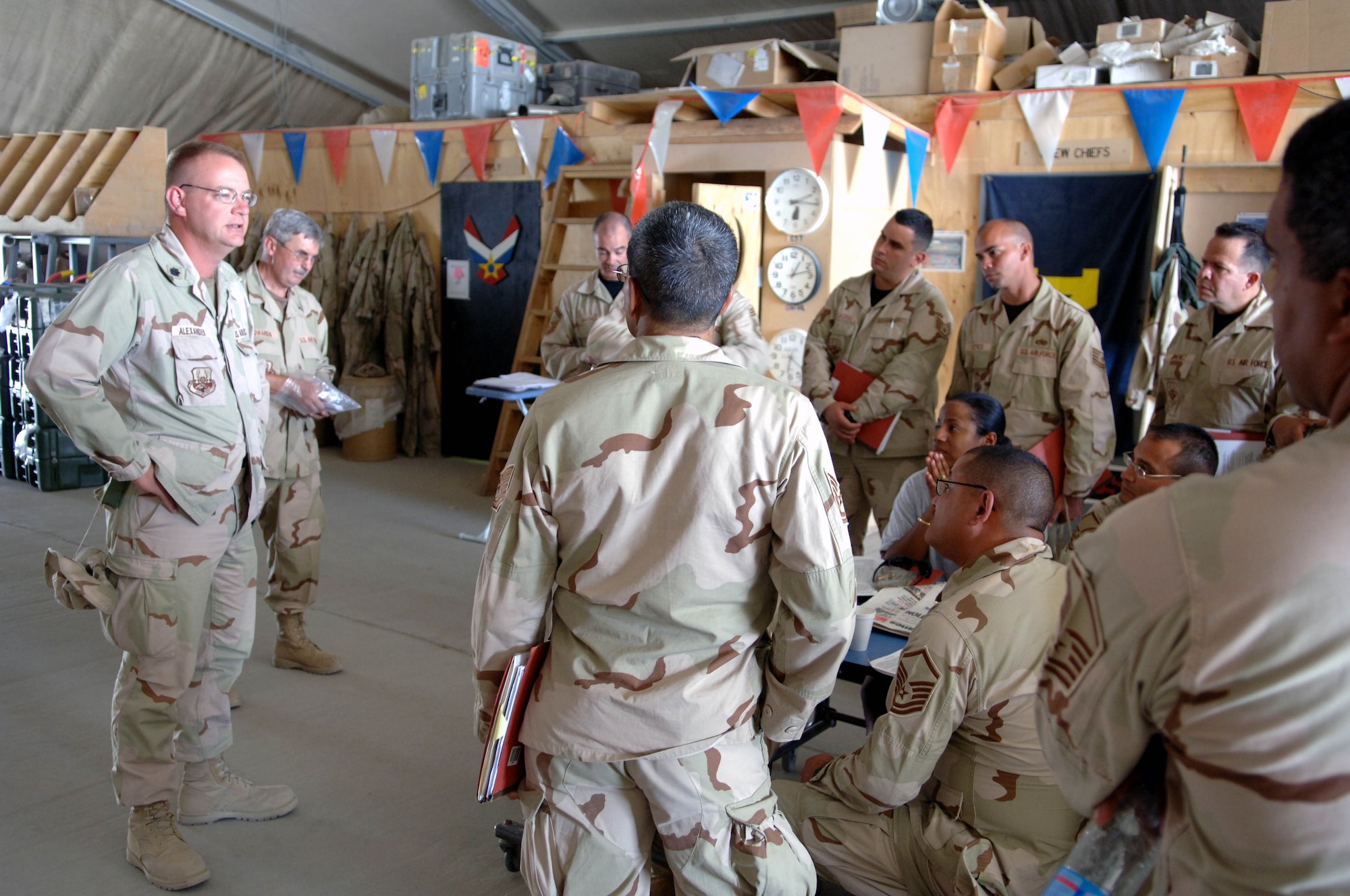 Lt. Col. Jeff Alexander, 455th Expeditionary Maintenance Squadron commander, addresses members of the Puerto Rico Air National Guard in the C-130 maintenance clam shell Sept. 9. It's the first time the Puerto Rico ANG has deployed as a unit to a war zone.