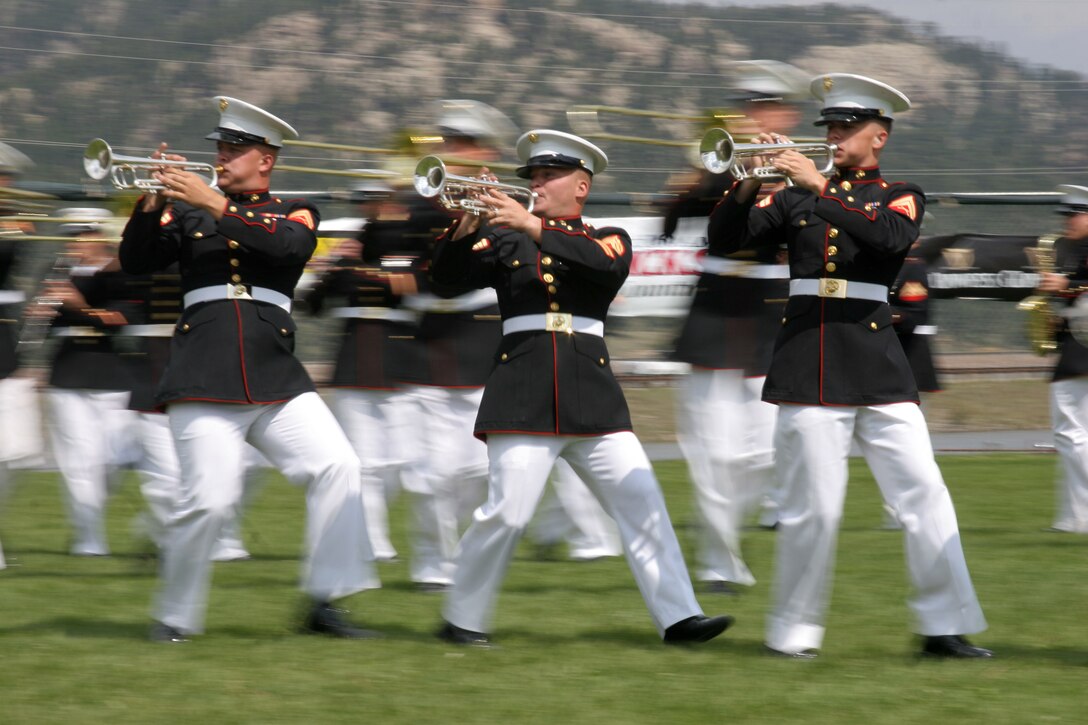 ESTES PARK, Colo. ? Maneuvering during a complex portion of ?Pirates of the Caribbean,? Cpl. Charles R. Bond, Staff Sgt. Michael R. Pratt and Cpl. Todd L. Austin, trumpet players with the Marine Corps Air Ground Combat Center Band, perform for hundreds during a daytime performance at the 30th Annual Longs Peak Scottish Irish Highland Festival Sept. 10.