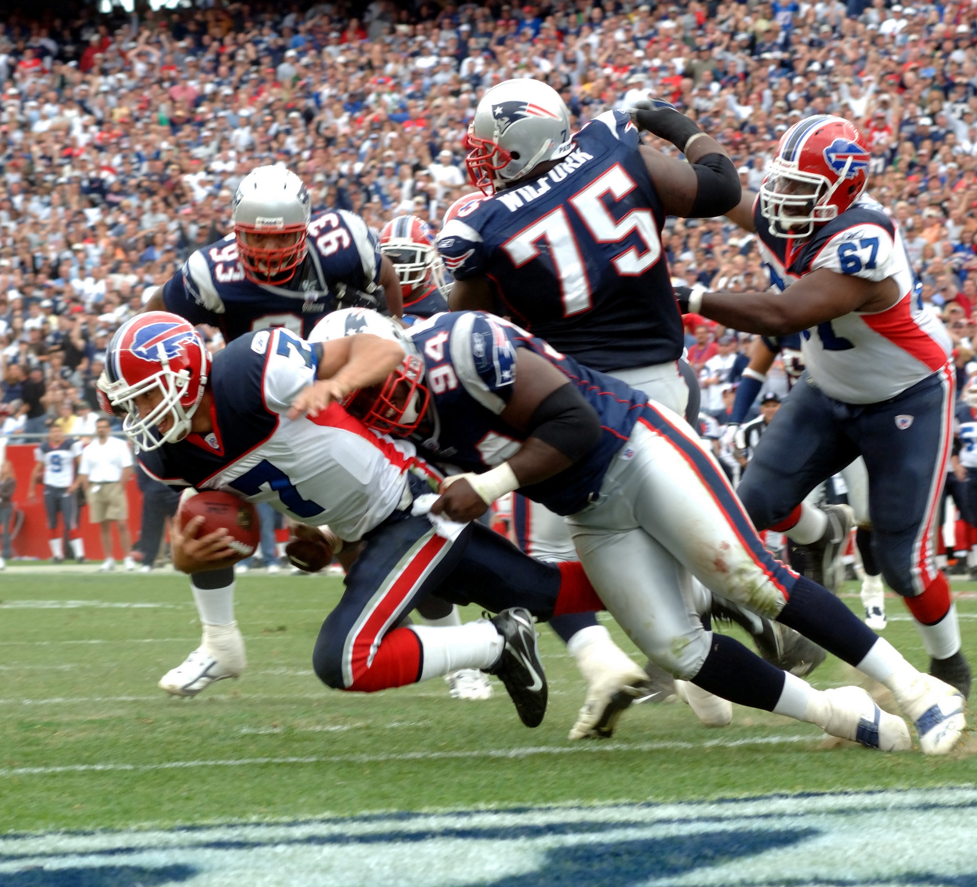 Buffalo Bills Quarterback J.P. Losman gets tackled in the endzone by Patriots left End Ty Warren for a safety during a crucial play in the fourth quarter on 10 Sep. Before the game, a B-2 Stealth Bomber from Whiteman Air Force Base, Mo., did a flyover that erupted the crowd and hundreds of recruits enlisted in the Army National Guard during halftime. New England went on to win the game played at Gillette Stadium, 19-17. (U. S. Air Force photo by Tech. Sgt. Larry A. Simmons)