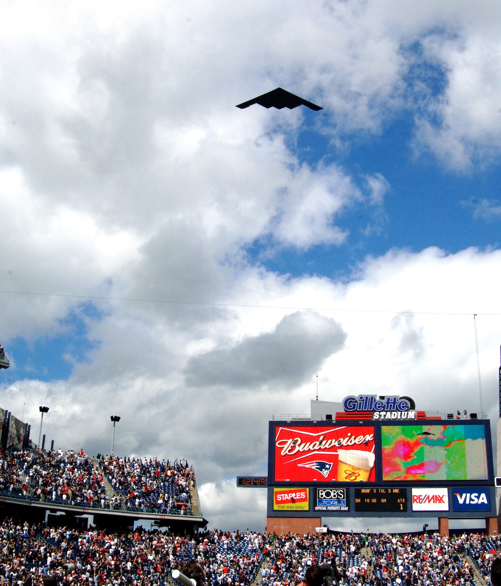 A B-2 Stealth Bomber from Whiteman Air Force Base, Mo., flies over Gillette Stadium moments before the New England Patriots and Buffalo Bills game on 10 Sep. During halftime,  hundreds of recruits were enlisted in the Army National Guard by Brigadier General Oliver Mason. New England won the game 19-17. (U.S. Air Force photo by Tech. Sgt. Larry A. Simmons)