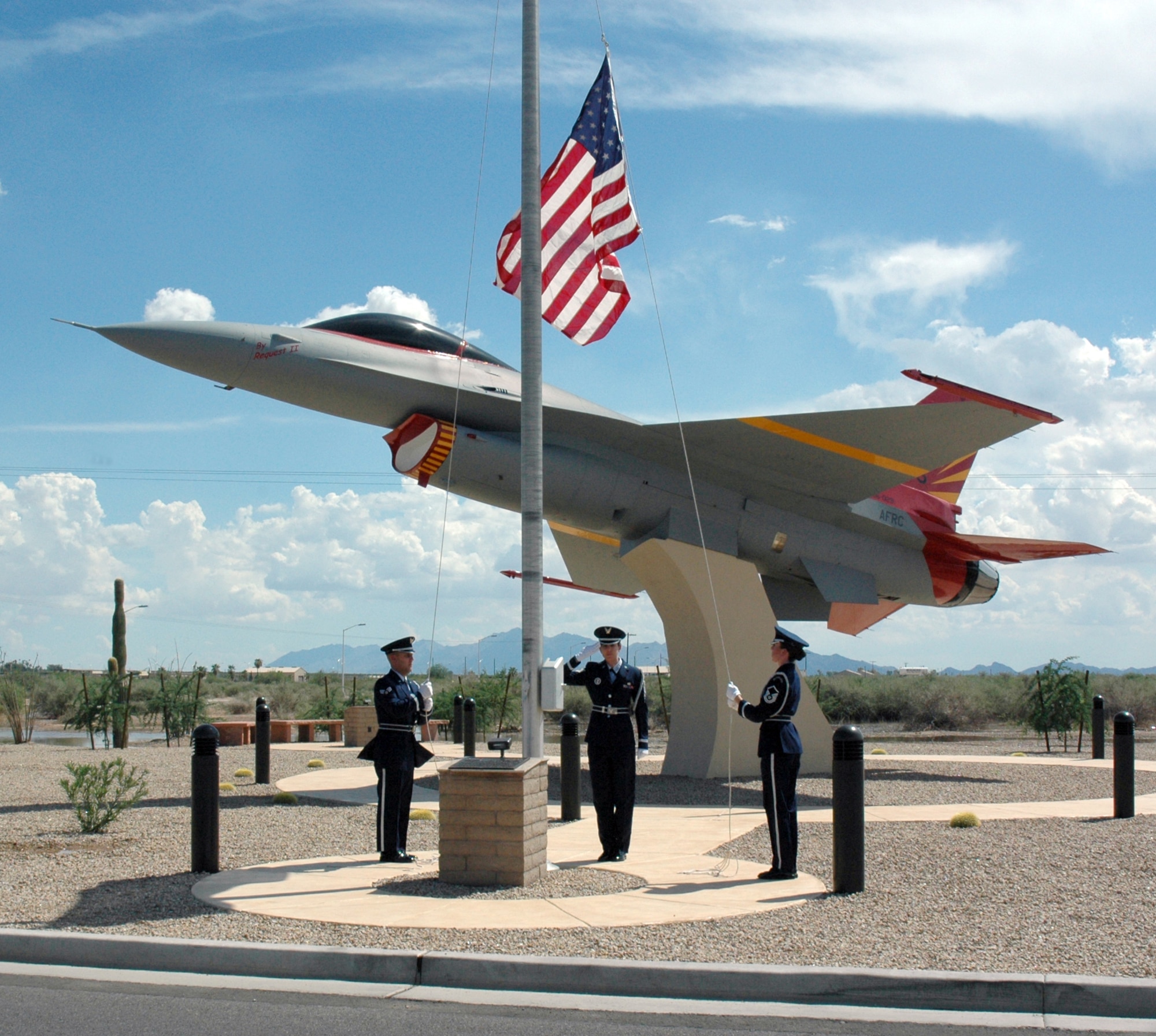 (Left to right) Senior Airman Robert Hall, Tech. Sgt. Sandra Montoya, and Master Sgt. Tara Richard, 944th Fighter Wing Honor Guard members, raise the American flag in honor of the fifth anniversary of the Sept. 11 terrorist attacks. (U.S. Air Force photo/Staff Sgt. Susan Stout)