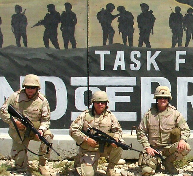 KIRKUK AIR BASE, Iraq -- TOTAL TEAM ? Air Force reservist Master Sgt. Scott C. Daigneault, center is flanked by his Total Force team members Senior Master Sgt. Robert Griffin, left, and Capt. Christopher Green of the Air National Guard. Sergeant Daigneault is deployed to a Southwest Asia location as first sergeant for the 506th Expeditionary Logistics Readiness Squadron (ELRS). The squadron provides aerial port, supply, vehicle maintenance, and fuels Airmen. Sergeant Daigneault, who is the 439th Maintenance Operations Squadron first sergeant when at Westover, has been at the base since late June, and is scheduled to return in mid-September. (US Air Force photo)