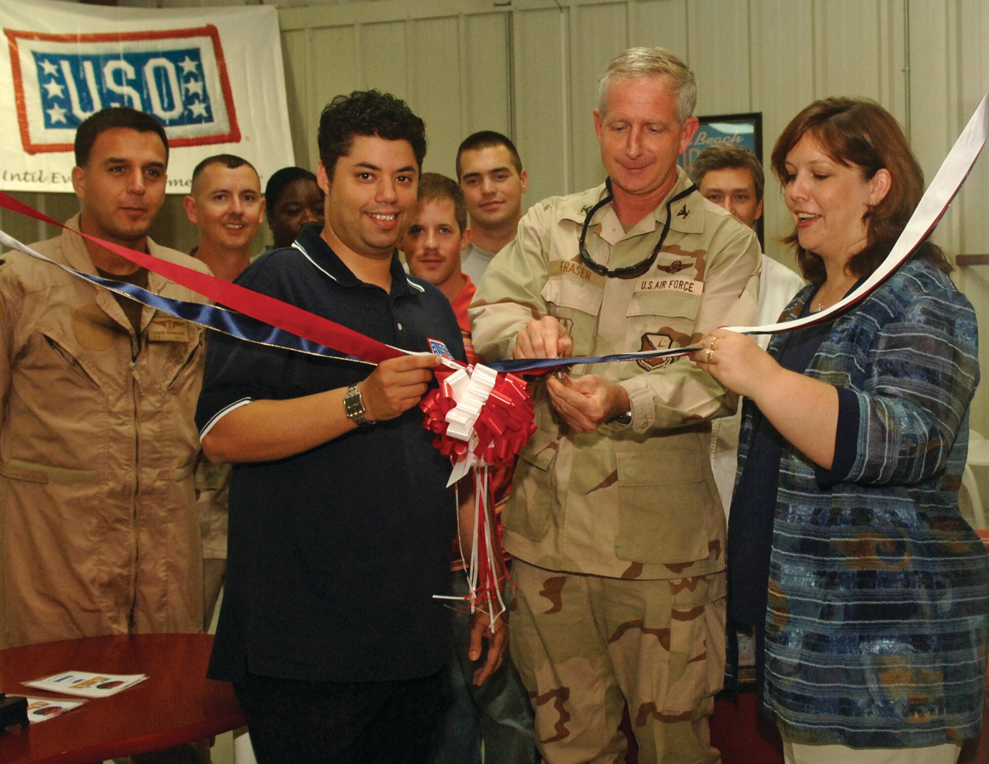 Col. Jeff Fraser, 379th Air Expeditionary Wing vice commander, cuts the ribbon on the new USO Monday. Jake Jacobs, USO director of the host nation center and Cara Nazari, USO vice president of operations in Southwest Asia helped the colonel open the new facility designed to benefit troops transiting through AUAB. Next year, the terminal hopes to receive funding and more amenities to offer those passing through the passenger terminal.