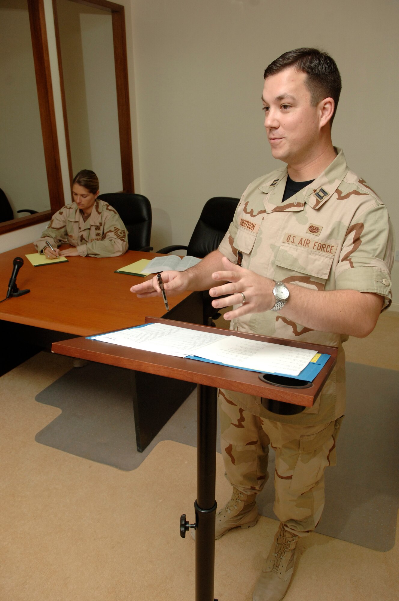 Capt. Jason Robertson, Area Defense Counsel, prepares for a case as Tech. Sgt. Stacy Snider, defense paralegal, takes notes. They are the  Area Defense Counsel team who just stood up the Air Force’s newest ADC office, serving any Airmen stationed in the AOR with legal support. (USAF photo by Master Sgt. Douglas Lingefelt)