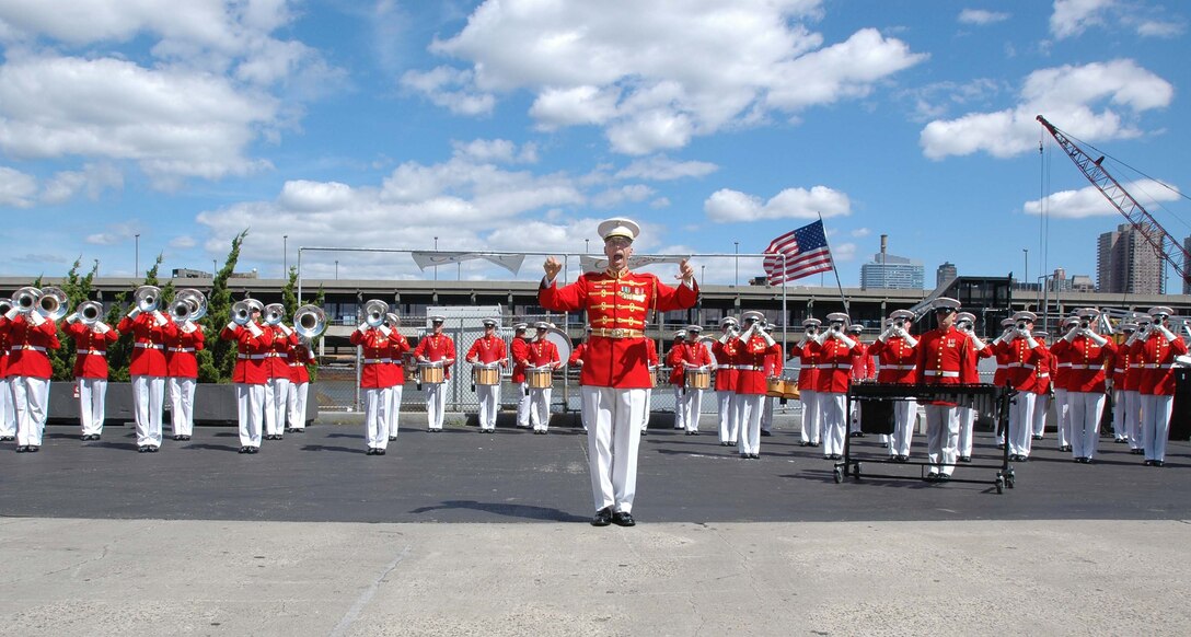 Chief Warrant Officer 4 Brian Dix, director of "The Commandant's Own" The United States Marine Drum and Bugle Corps, directs his Marines while they play the National Anthem at the Intrepid Air and Space Museum, Sept. 11, 2006 in honor of those who died five years ago.