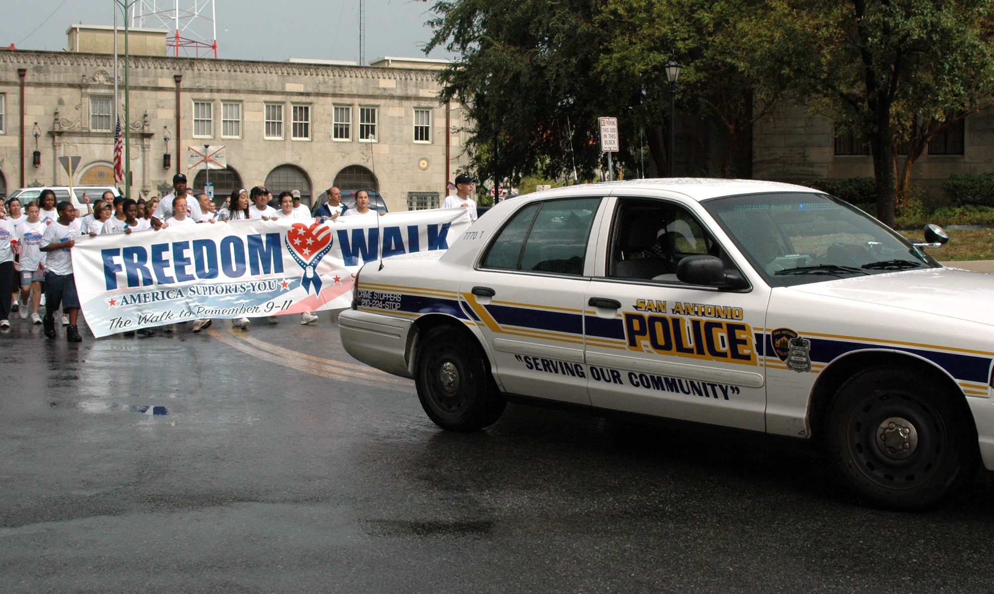 A patrolman from the San Antonio Police Department clears the way for the more than 1,200 servicemembers, civilians and children who braved the rain to participate in the America Supports You Freedom Walk Sept. 11 to pay tribute to those who died on Sept. 11, 2001. (U.S. Air Force photo/Tech. Sgt. Phyllis Duff)