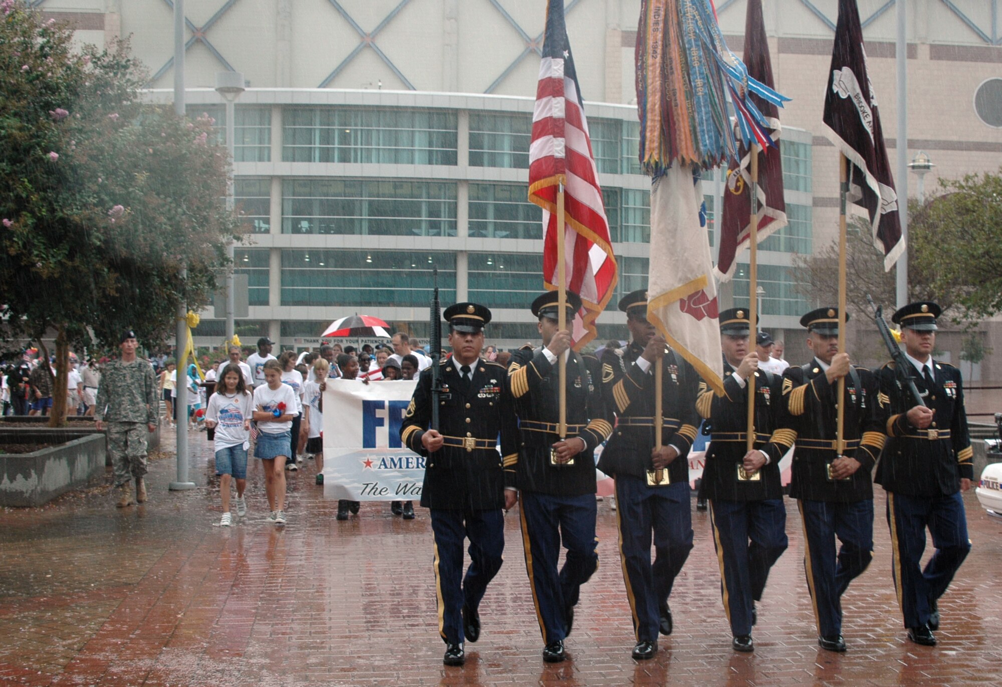 The joint color guard from nearby Fort Sam Houston marches down the street near the Alamo Dome leading more than 1,200 servicemembers, civilians and children who participated in the America Supports You Freedom Walk held in downtown San Antonio Sept. 11 to pay tribute to those who died on Sept. 11, 2001. (U.S. Air Force photo/Tech. Sgt. Phyllis Duff)