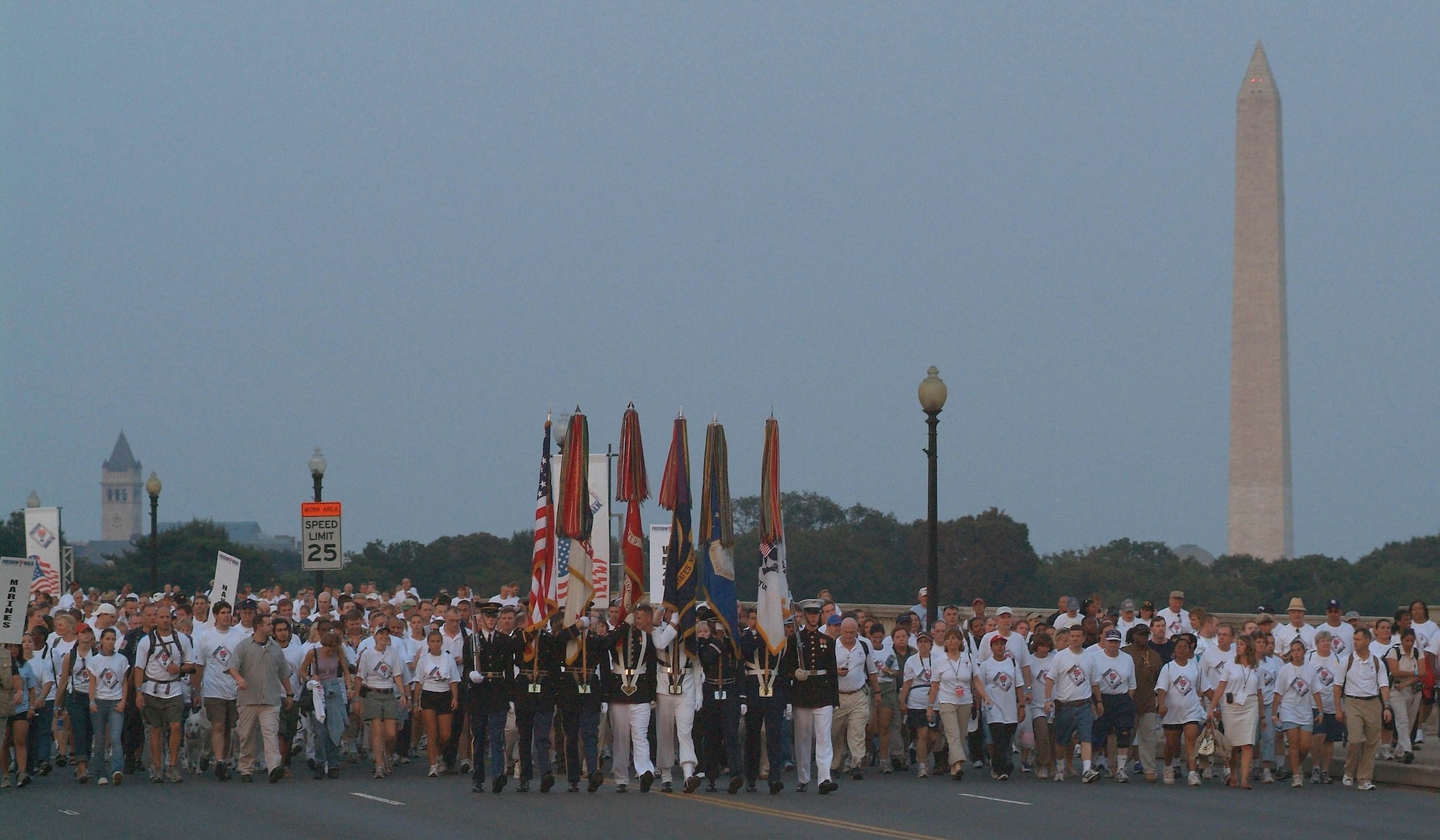 A joint-service honor guard leads thousands of people over the Memorial Bridge in Washington, D.C., Sept. 10, during the Pentagon's 2nd Annual America Supports You Freedom Walk. The walk commemorates the 5th anniversary of the Sept. 11, 2001, terrorist attacks. (U.S. Navy photo/Chief Mass Communication Specialist Mate Johnny Bivera)