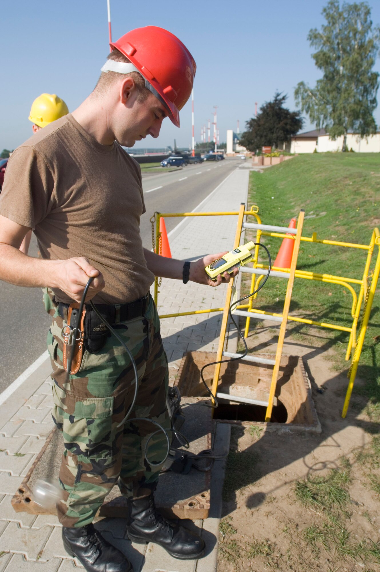 Airman 1st Class Jeremi Welborn zeroes the gas detector before placing it into a manhole at Ramstein Air Base, Germany, Sept. 11. Airman Welborn is a cable maintainer with Ramstein's 435th Communications Squadron. (U.S. Air Force photo/Master Sgt. John E. Lasky) 
