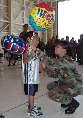 Staff Sgt. Mary Anne Viloria shares a moment with her 7-year-old son, R.J., during a welcome home celebration at Andersen Air Force Base, Guam, Sept. 10. Members from the 36th Medical Group, 36th Wing and the U.S. Navy Helicopter Sea Combat Squadron 25 returned home following a 72-day humanitarian and civic assistance deployment on the USNS Mercy. Sergeant Viloria is assigned to the 36th MDG. (U.S. Air Force photo/Senior Airman Angelique Smyth)