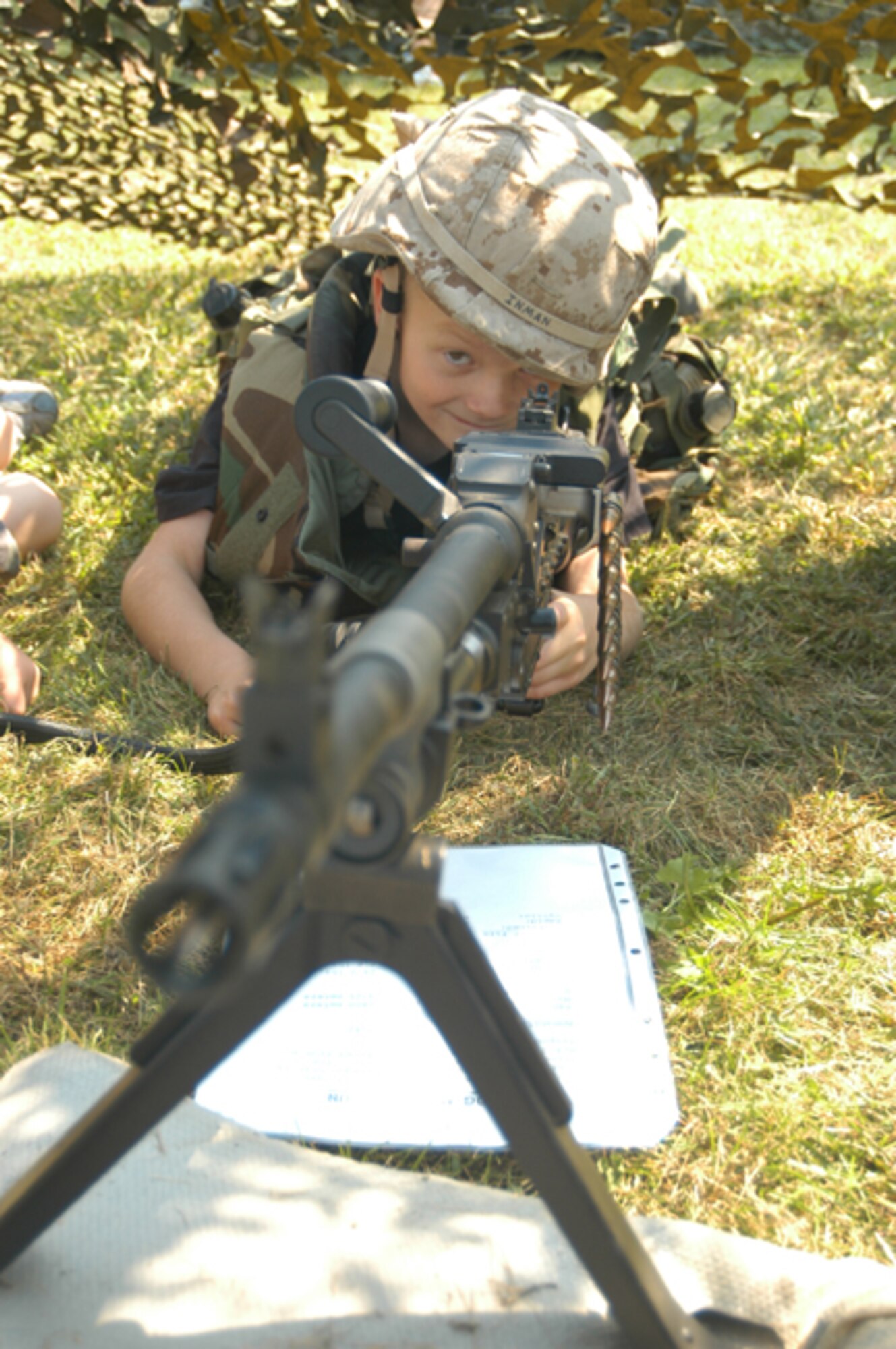 GRISSOM AIR RESERVE BASE, Ind -- Greg Mahoy, son of Staff Sergeant Ron Mahoy, pretends to fire with a static display machine gun provided by the Marine Corps Reserve Center. Families of Air Force Reserve, Navy Reserve, Army Reserve and Marine Corps Reserve units at Grissom came together for a fun and educational day during the annual Joint Family Day Picnic. Sergeant Mahoy is a fire team member with the 434th Security Forces Squadron.  (U.S. Air Force photo/SrA Mark Orders-Woempner)