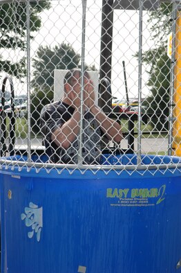 GRISSOM AIR RESERVE BASE, Ind -- Maj. Chuck Good, 434th Air Refueling Wing executive officer, wipes the water from his eyes after being dunked in the dunk tank during the joint family picnic.  Families from Air Force Reserve, Army Reserve, Navy Reserve and Marine Corps Reserve units at Grissom, along with military retirees, came together for a fun and educational day.  (U.S. Air Force photo/SrA. Ben Mota) 