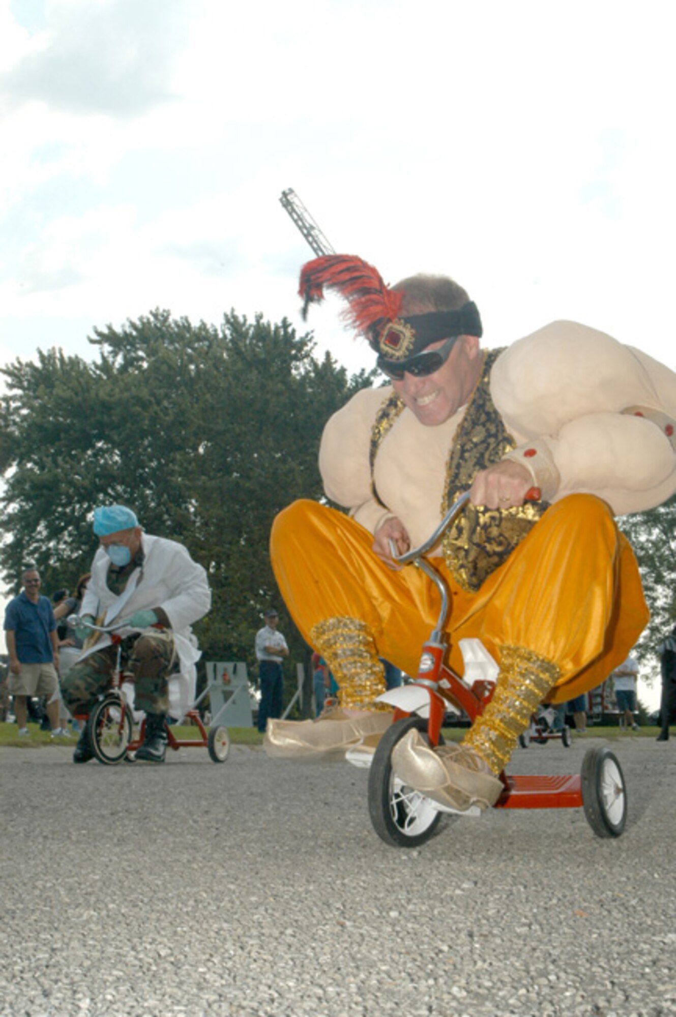 GRISSOM AIR RESERVE BASE, Ind -- Lt. Col. Tim Cox, 74th Air Refueling Squadron commander, powers his way toward the finish line during a tricycle race at this year's Joint Family Day Picnic. Each year, commanders battle it out to see who can pilot the three wheeled devices with the most speed and skill. Costumes were also required of race participants.  (U.S. Air Force photo/ SrA. Mark Orders-Woempner)
