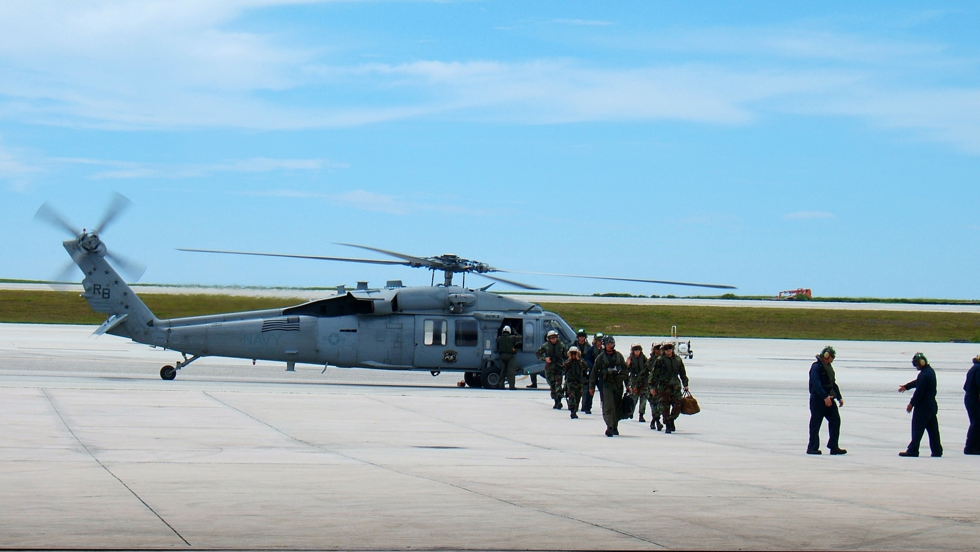 ANDERSEN AFB, Guam - Members from the 36th Medical Group, from the 36th Wing and the U.S. Navy Helicopter Sea Combat Squadron 25, stationed at Andersen Air Force Base, Guam disembark from a MH-60S helicopter after returning home Sunday following a 72-day humanitarian-and-civic-assistance deployment on the USNS Mercy.   The members participated in theater security cooperation and medical assistance missions in partnership with non-governmental organizations, international military medical personnel and host nations of the Philippines, Bangladesh, Indonesia and East Timor.  (Photo by: 36th Medical Group)