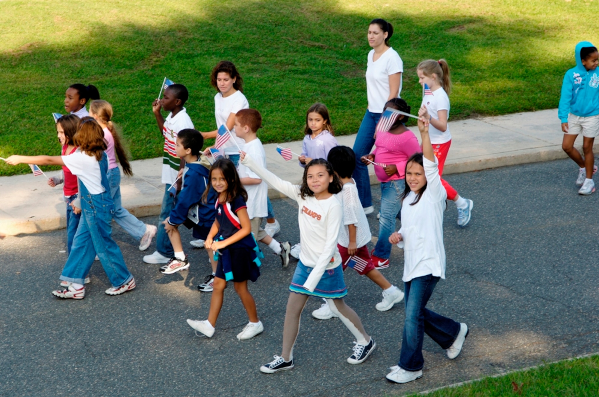Students with the Columbia School and Discovery schools, North Hanover, New Jersey wave American flags during the Freedom Walk taking place in remembrance of the fifth anniversary of September 11, 2001. Third and fourth grade students from the Columbia and Discovery schools, North Hanover, New Jersey along with Airmen from McGuire Air Force Base and the local community participated in the walk on September 11, 2006. USAF photo by Denise Gould.