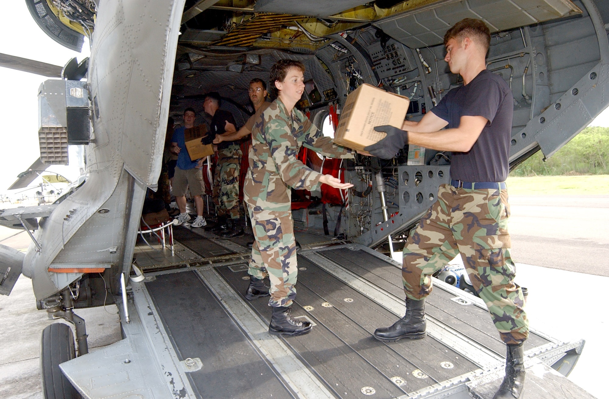 First Lt. Kristina Evener and Senior Airman Ben Hastings help a team of servicemembers load cases of water and Meals, Ready to Eat, into a CH-47 Chinook helicopter Sept. 10. Airmen and Soldiers are responding to a request for help from the U.S. Embassy in Nicaragua after more than 30 people died in the city of Leon from a toxic batch of moonshine laced with methanol. The Airmen are with Joint Task Force Bravo's Air Force Forces logistics flight. (U.S. Air Force photo/Senior Airman Mike Meares)