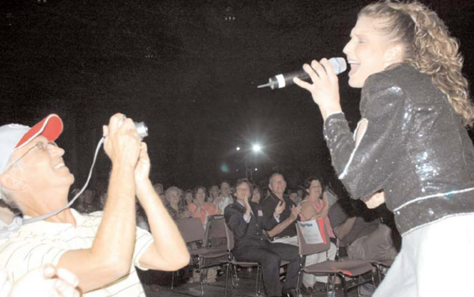 Airman 1st Class Naomi Keen belts out a solo while Walt Czepiga takes a few photos.(U.S Air Force Photo/Valerie Mullet)
