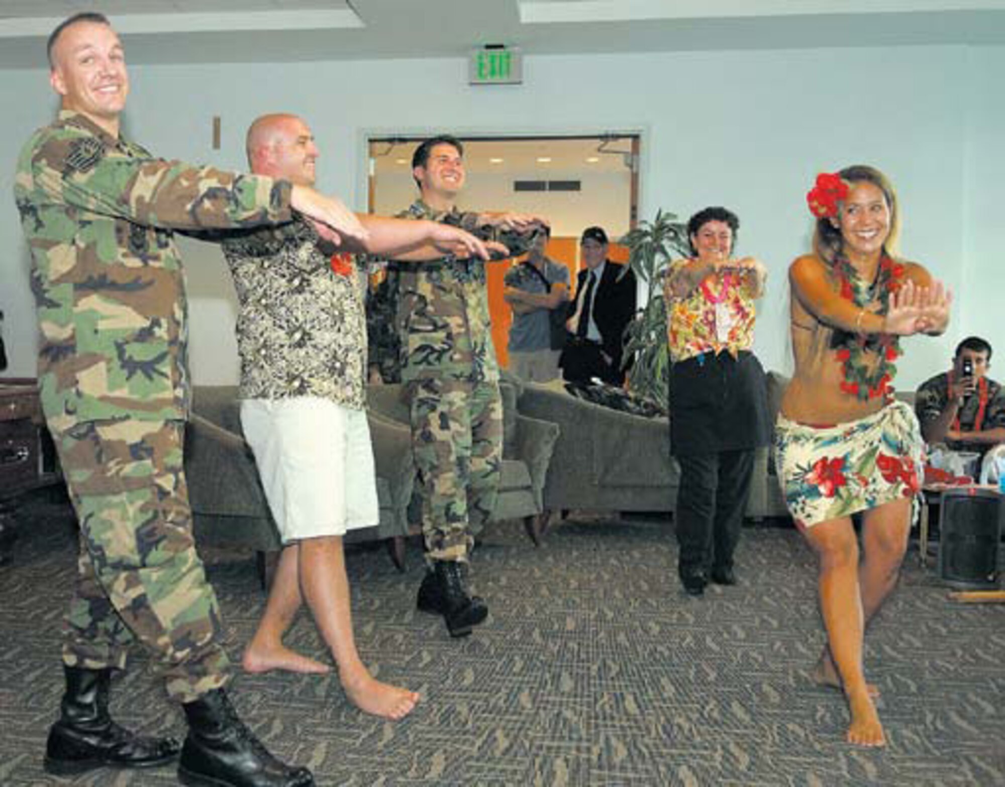 The Club went Hawaiian during its first Aloha Thursday event, Aug. 17. Hawaiian food and fun were the order of the day starting with breakfast featuring banana and coconut pancakes. Lunch menu consisted of a pork carving station, pineapple salsa, Hawaiian chicken with plum plaze, Hawaiian fried rice and free dessert. The afternoon Luau served free Hawaiian pupus (hors d?oeuvres). Hula dancers performed and also gave hula lessons. Giveaways and adrawing completed the day. The Aloha Thursday celebrated the Hawaiian culture and was an opportunity for base personnel to relax and have a great time. (Information courtesy 61st Air Base Wing Services Office.)

Participants enjoyed a lesson in Hawaiian
hula dancing instructed by one of the members
of the Hula Entertainers.
