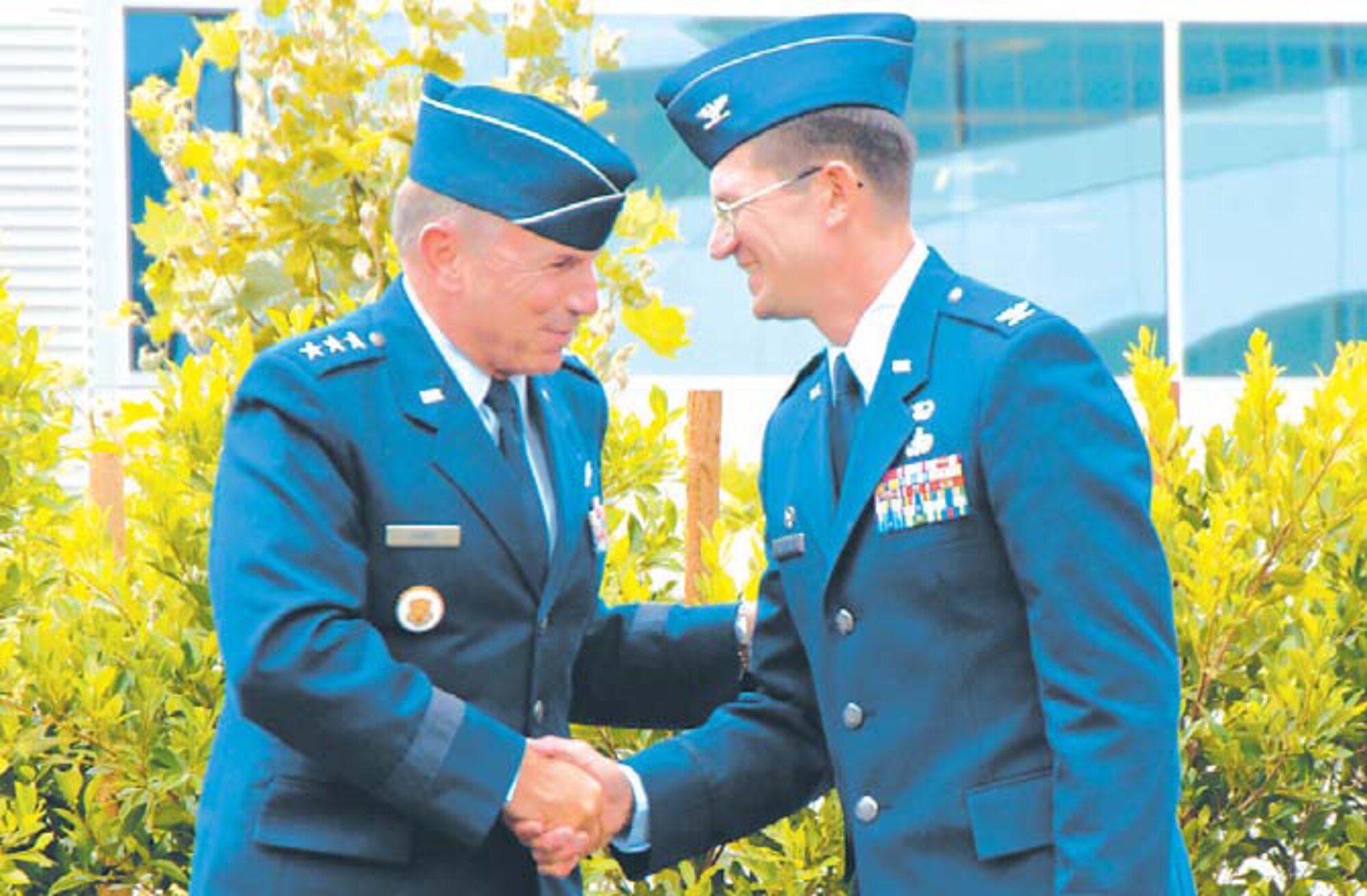 Lt. Gen. Michael Hamel (left), Space and Missile Systems Center commander, welcomes aboard the 61st Air Base Wing commander, Col. Joseph Schwarz. The Wing stand-up took place at the Los Angeles Air Force Base?s Schriever Space Complex courtyard, July 31.