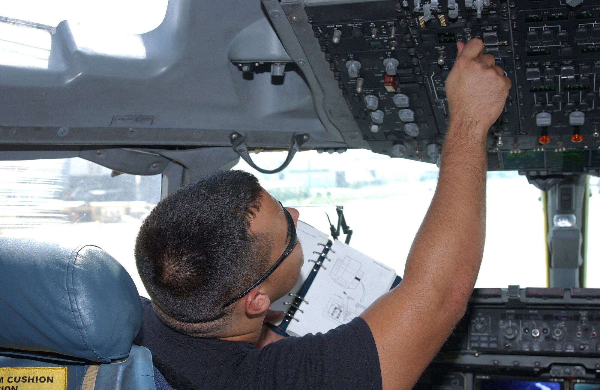 INCIRLIK AIR BASE, Turkey -- Staff Sgt.  Reliot Rodriguz, 728th Air Mobility Squadron C-17 Globemaster III crew chief, checks the switches on a C-17 aircraft assigned to the 385th Air Expeditionary Group during a preflight check on Sept. 11. C-17s from the 385th AEG squadrons at Incirlik, Manas Air Base, Kyrgyzstan, and its squadron in Southwest Asia flew sorties Sept. 11 to commemorate the three attack sites -- New York, Washington and Pennsylvania. The sorties schedule take offs to coincide with the attacks five years ago.  (U.S. Air Force photo by Airman First Class Tiffany A. Colburn)                                    