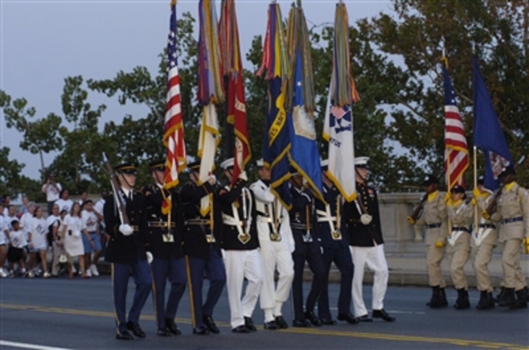 Members of the National Guard Youth Challenge Program (right) prepare to change places with the Joint Service Color Guard on Memorial Bridge during the America Supports You Freedom Walk in Washington, D.C., Sept. 10, 2006. 
