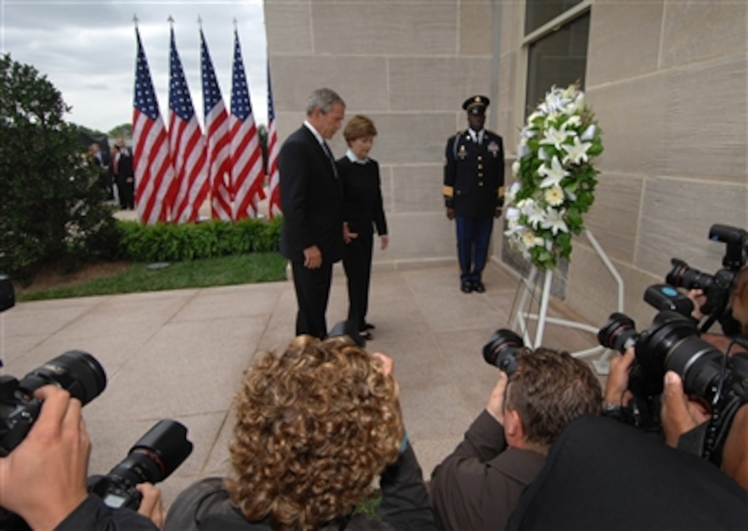 President George W. Bush and first lady Laura Bush stand before a wreath placed at the crash site of Flight 77 on the fifth anniversary of the Sept. 11, 2001, terrorist attack on the Pentagon. 