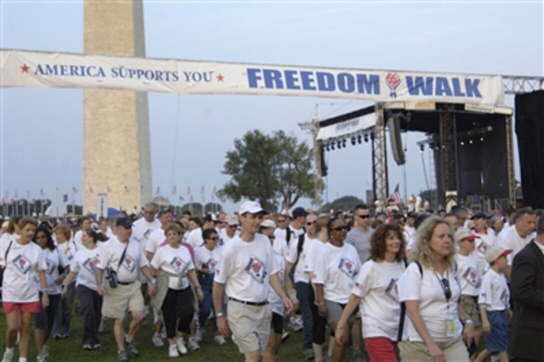 Thousands of participants walk past the Washington Monument during the 2nd annual America Supports You Freedom Walk in Washington D.C., on Sept. 10, 2006, to honor those that lost their lives Sept. 11 as a result of a terrorist attack in New York, Washington and Pennsylvania five years ago.  