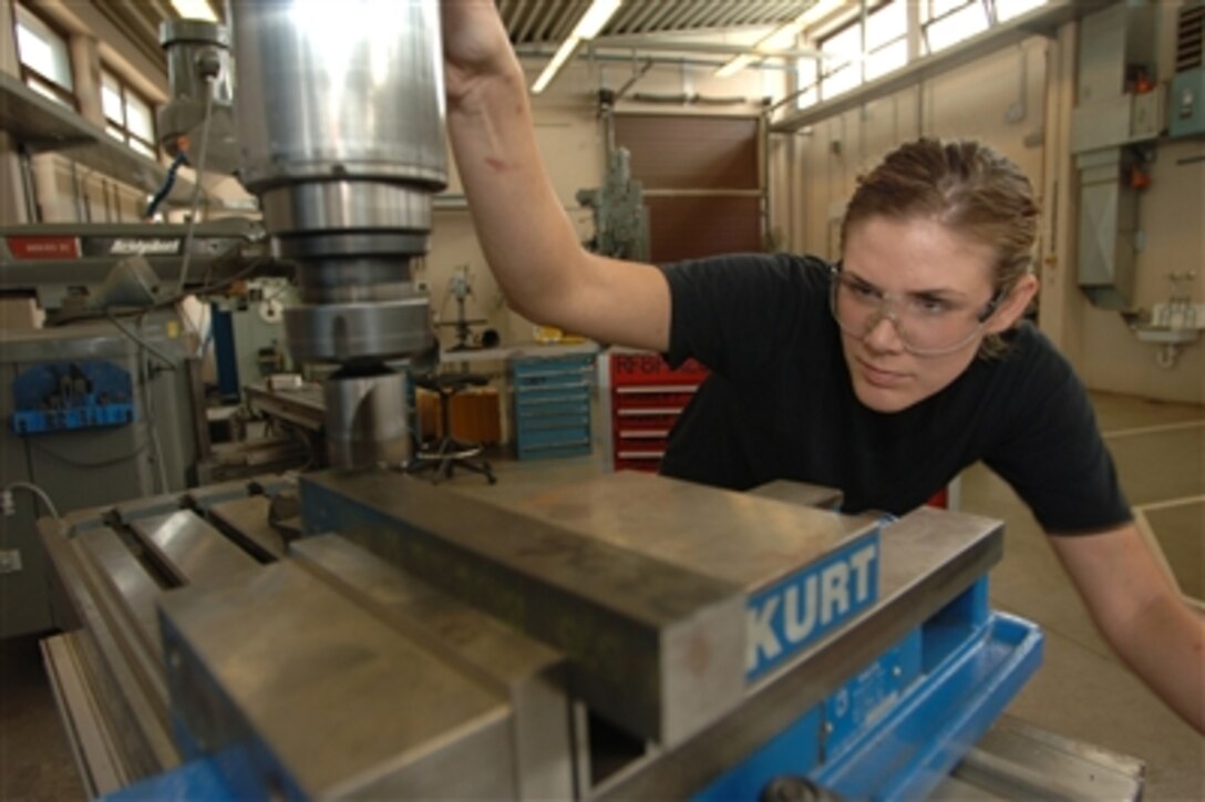 U.S. Air Force Senior Airman Michele Wilkes smoothes out a piece of metal for a C-130 Hercules aircraft at Ramstein Air Base, Germany, on Aug. 24, 2006.  Wilkes is assigned as a metals technician with 86th Maintenance Squadron.  