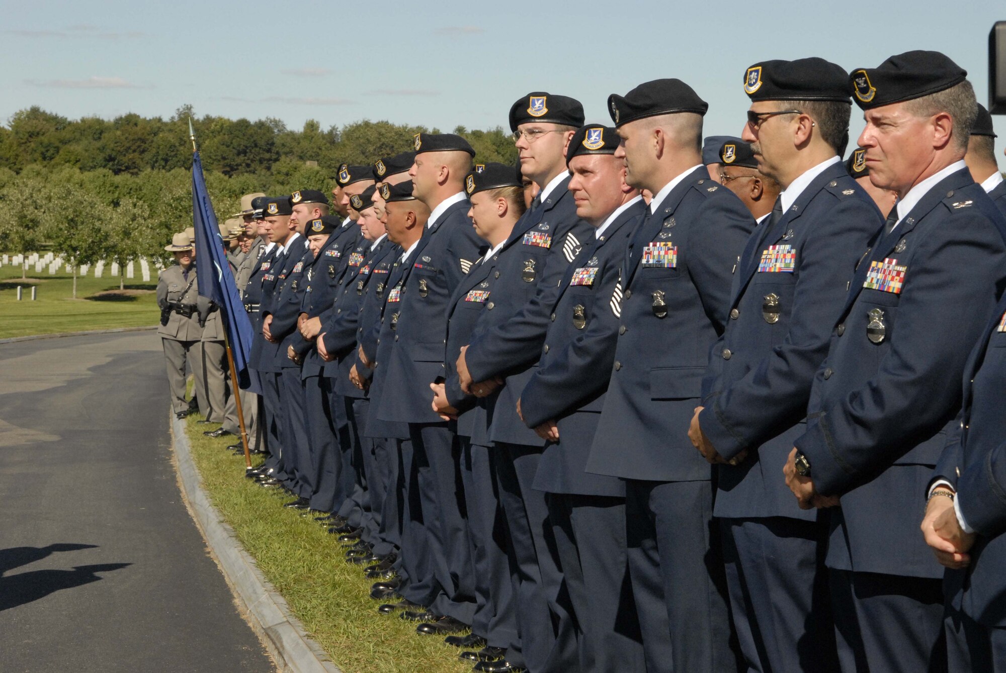 Airmen with the New York Air National Guard's 109th Airlift Wing stand in formation Sept. 11 waiting for the burial ceremony for Master Sgt. Joseph Longobardo to begin.  Sergeant Longobardo, a guardsman with the 109th Security Forces Squadron, was a New York State Police officer who was killed in the line of duty Sept. 3 while participating in the manhunt for fugitive Ralph "Bucky" Williams.  (U.S. Air Force photo/Tech. Sgt. Cathy Perretta)