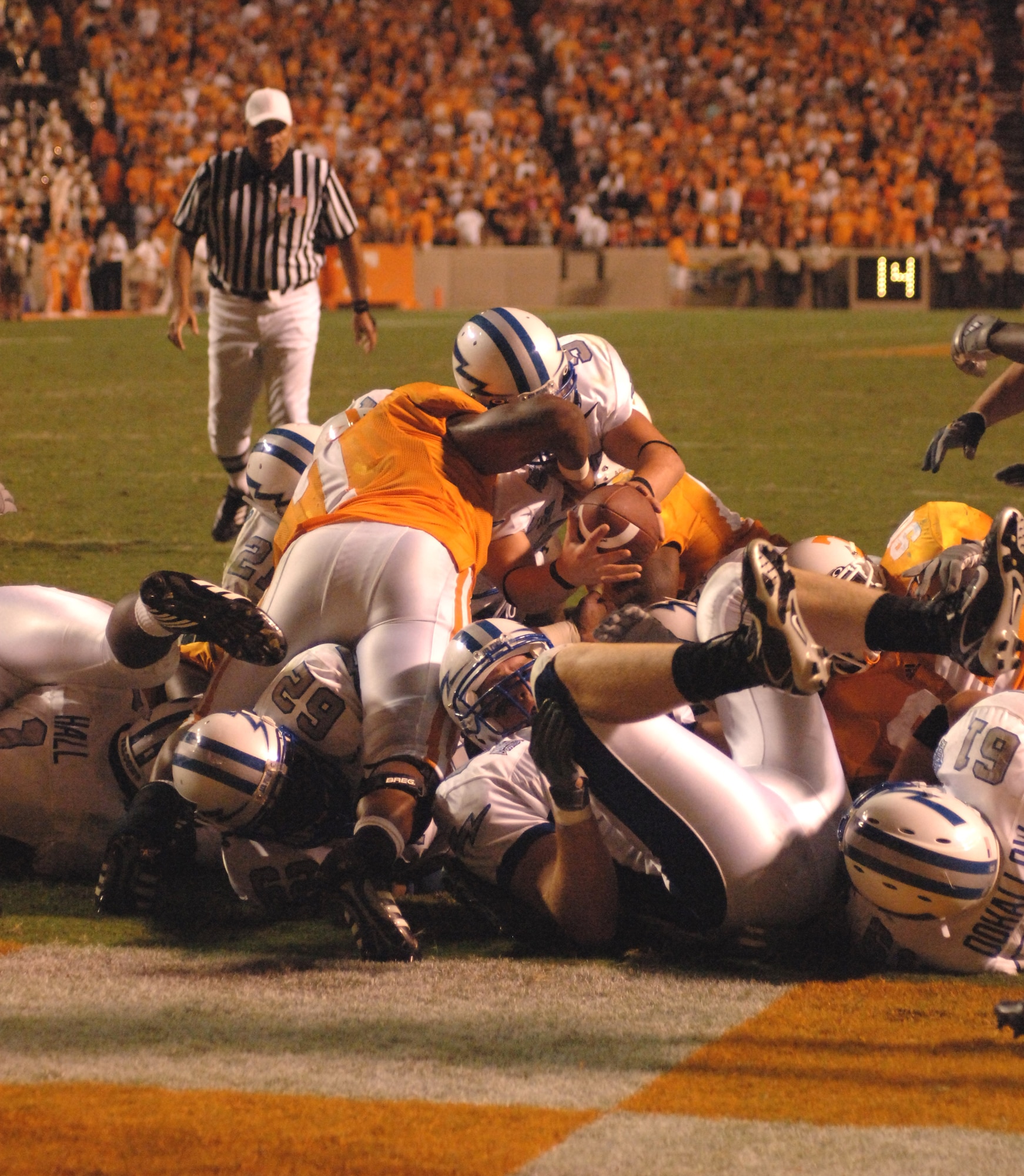 Air Force Academy Falcons quarterback Shaun Carney stretches over the Tennessee line to score on a quarterback sneak Sept. 9.  The third-quarter play pulled the Falcons within seven points of #11-ranked Tennessee.  The Volunteers went on to edge the Falcons, 31-30.  (U.S. Air Force Photo/John Van Winkle)