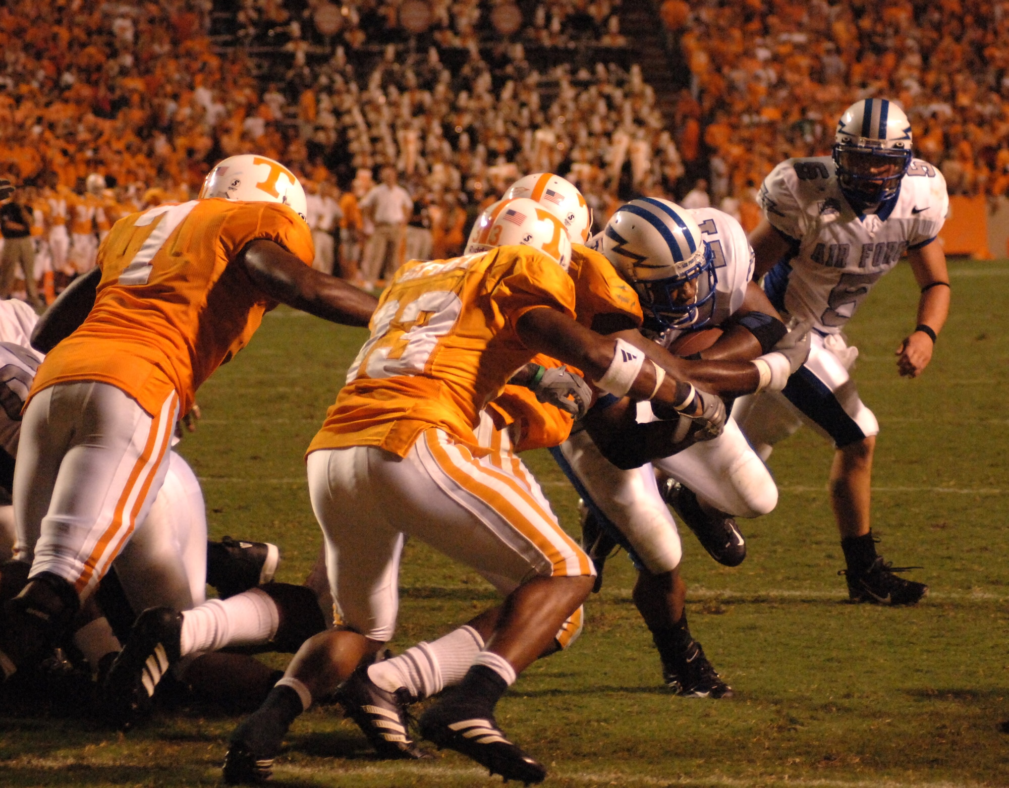 Air Force Academy Falcon fullback Ryan Williams (#21) lowers his shoulder as Tennessee defenders swarm to him.  Williams ran 16 times for 98 yards, but #11 Tennessee was able to hold on to edge the Falcons, 31-30, Sept. 9.  (U.S. Air Force Photo/John Van Winkle)
