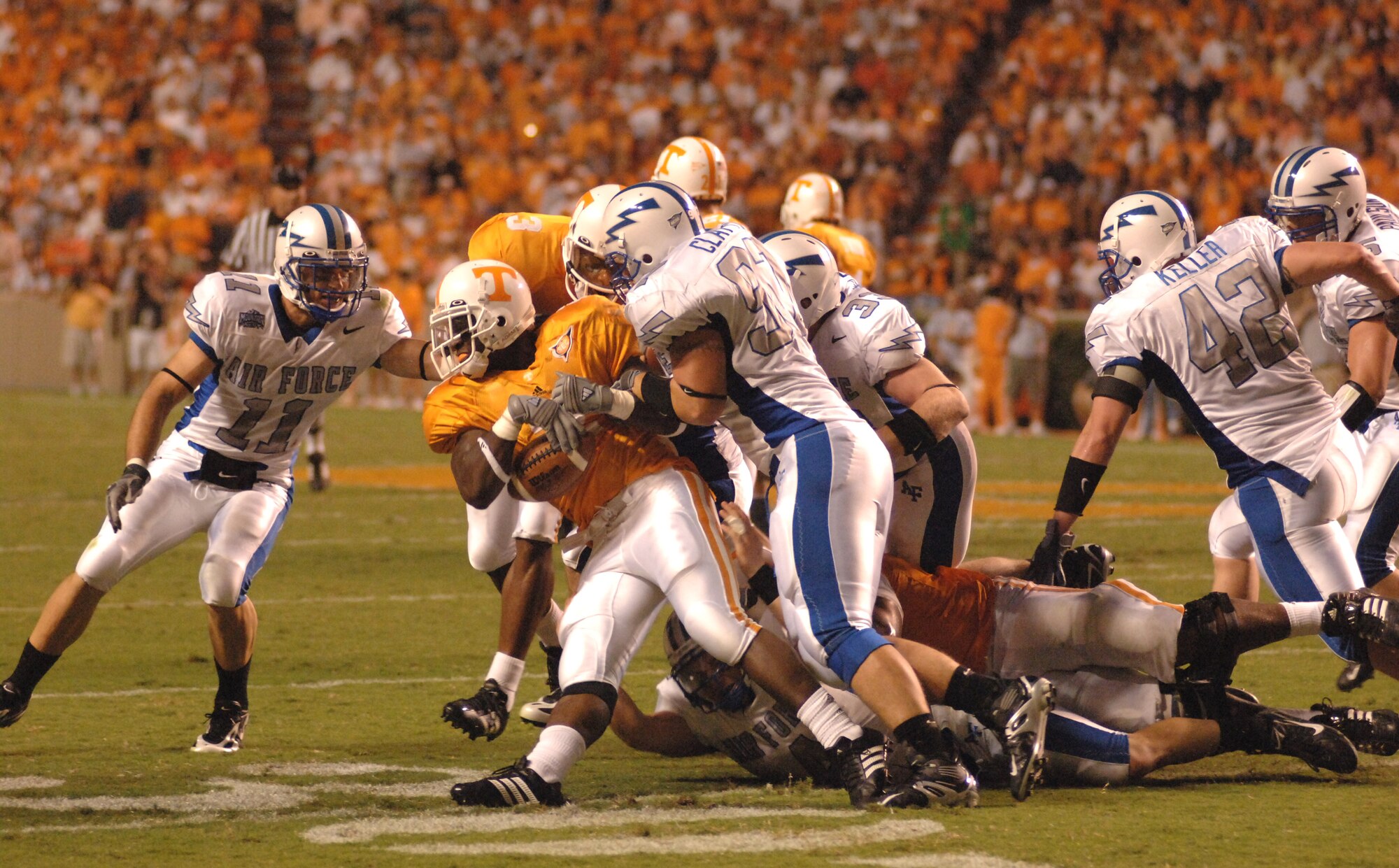 Air Force Academy Falcons free safety Bobby Giannini (#11) prepares to finish off Tennessee tailback Montario Hardesty, while Falcons defensive end Josh Clayton (#97) loosens Hardesty's grip on the football.  The freshman tailback ground out 63 of Tennessee's 79 yards on the ground and added one touchdown to the Volunteers' 31-30 win over Air Force Sept. 9.  (U.S. Air Force Photo/John Van Winkle)