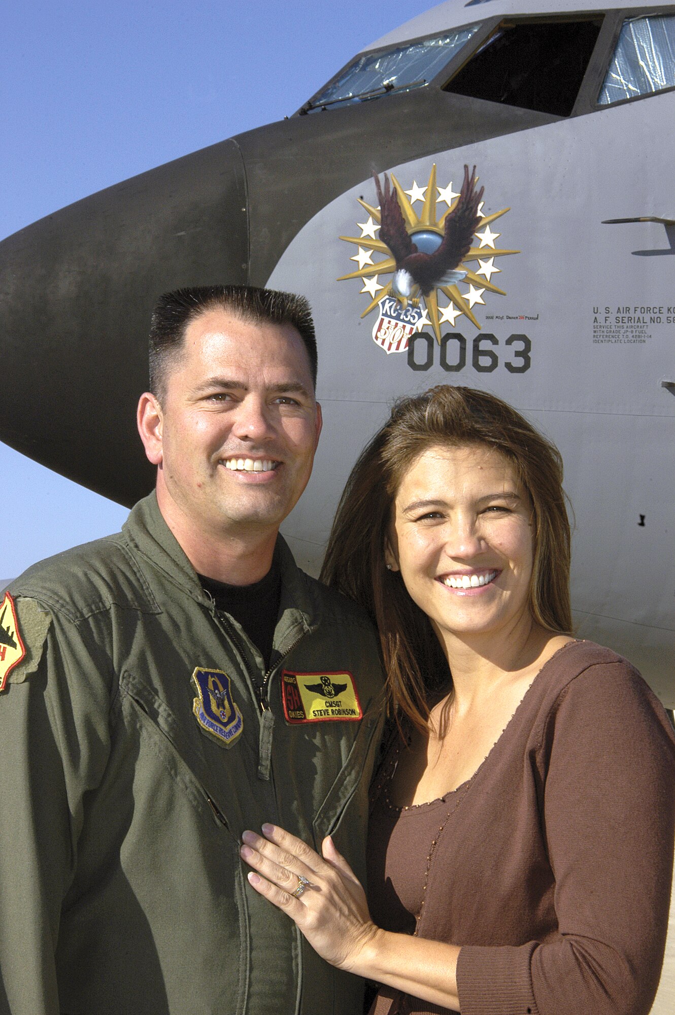 Chief Master Sgt. Steven Robinson and his wife Justine said "I do" aboard a KC-135 Stratotanker 15 years ago. Today, in front of the familiar aircraft with special 50th anniversary nose art, they reminisce about their marriage's unconventional beginning. (U.S. Air Force photo/Margo Wright) 

