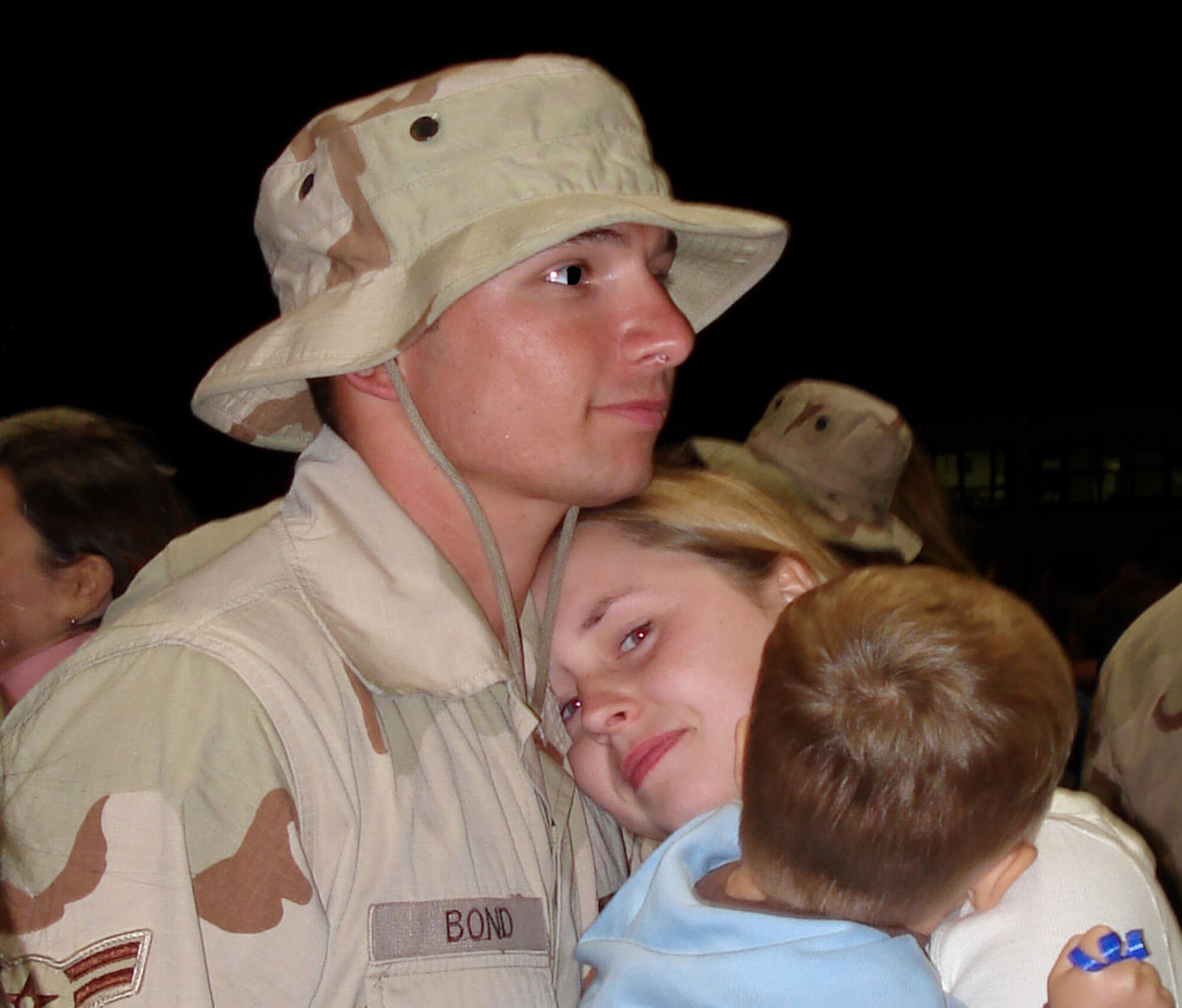 Senior Airman Cody Bond greets his wife, Kristy, and son, Caleb, upon his return to Spangdahlem Air Base, Germany, Sept. 9 from a deployment to Southwest Asia. He is assigned to the 52nd Aircraft Maintenance Squadron. (U.S. Air Force photo/Capt. Diane Weed) 

