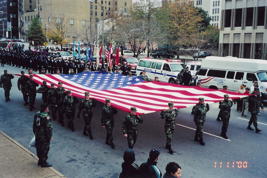 Members of the 932nd Airlift Wing at Scott AFB, Ill., carry an oversized flag during a Veteran's Day parade.