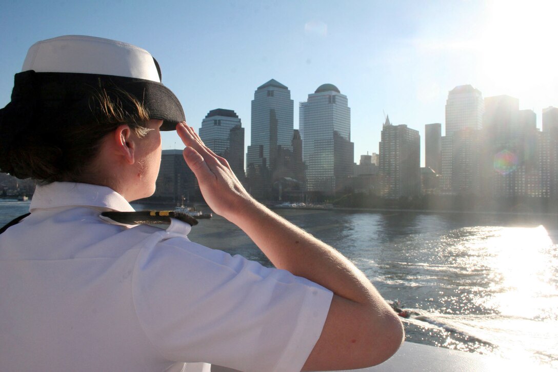 U.S. Navy Lt. j.g. Heather Twiggs, stationed aboard the amphibious transport dock ship USS San Antonio, renders a salute, Sept. 11, 2006, to the city of New York as the ship passes Ground Zero in New York City. The San Antonio and her crew are in New York to commemorate those who lost their lives five years ago during the 9/11 terrorist attacks on New York, the Pentagon and Shanksville, Pa.
