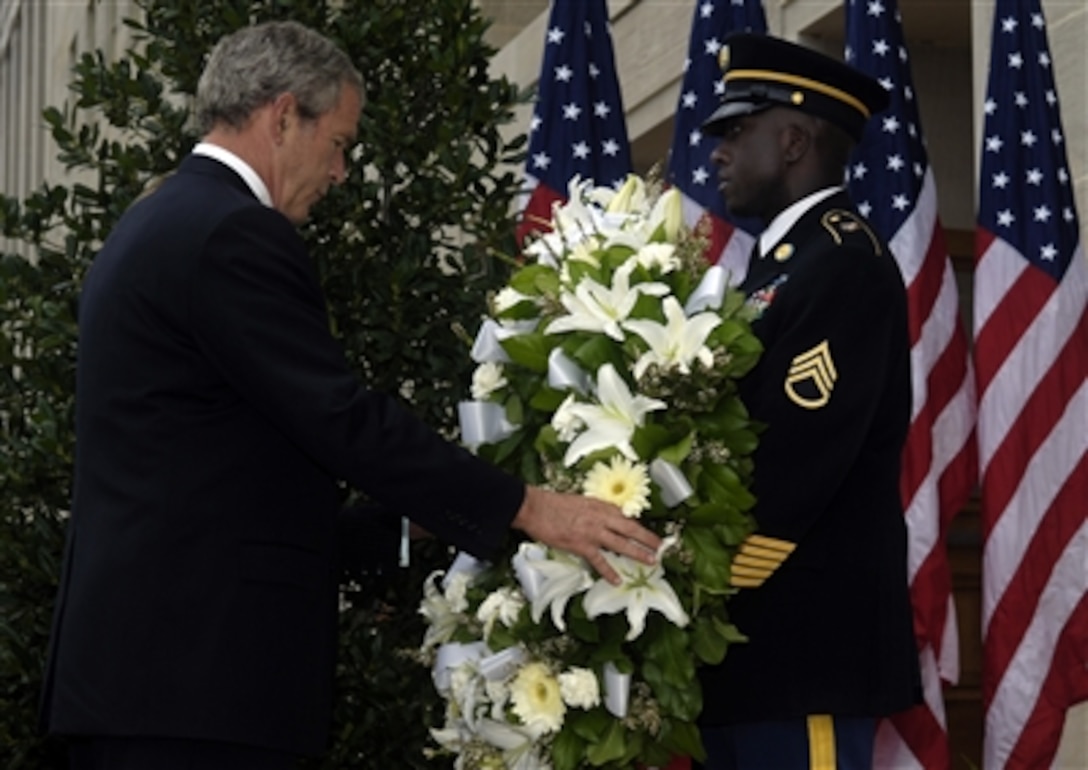 President George W. Bush and Mrs. Bush lay a wreath at the crash site of Flight 77 during a ceremony in observance of the fifth anniversary of the Sept.11th terrorist attack at the Pentagon on Sept. 11, 2006.  