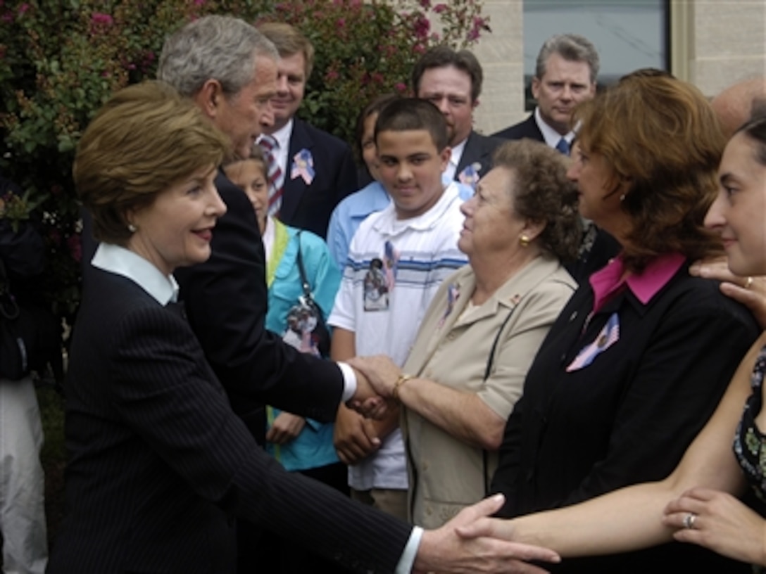 President George W. Bush and First Lady Laura Bush meet with family members of those who lost their lives at the Pentagon on Sept. 11, 2001, after a wreath laying ceremony at the crash site of Flight 77 at the Pentagon on Sept. 11, 2006.  
