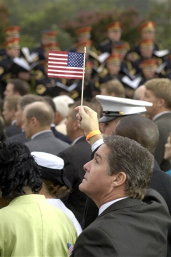 A member of the audience at the Pentagon raises a flag during the Sept. 11, 2006, ceremonies marking the 5th anniversary of the terrorist attack on the building.  Vice President Dick Cheney, Secretary of Defense Donald H. Rumsfeld and Chairman of the Joint Chiefs of Staff Marine Corps Gen. Peter Pace addressed the audience of the families of the 184 people killed in the attack and Pentagon employees. 
