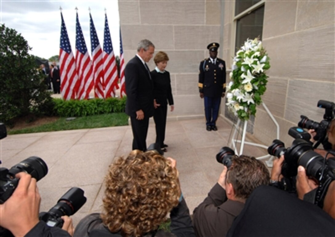 President George W. Bush and First Lady Laura Bush pause for a moment of reflection after laying a wreath at the crash site of Flight 77 during a ceremony in observance of the fifth anniversary of the Sept.11th terrorist attack at the Pentagon on Sept. 11, 2006.  