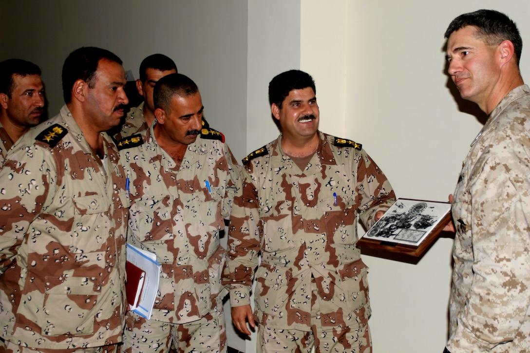 UMM QASR, Iraq (June 15, 2006) ? Col. John W. Bullard, commanding officer, 11th Marine Expeditionary Unit (Special Operations Capable), hands an 11th MEU (SOC) plaque to the commodore of the Iraq Army in Um Qasr.